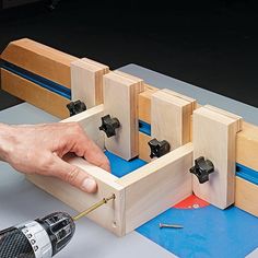 a person working with woodworking tools on a workbench that is being built