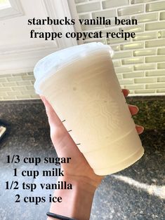 a person holding up a cup with instructions on how to make starbucks vanilla bean frappe copycat recipe