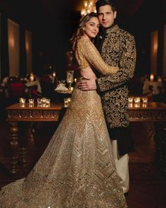 a man and woman dressed in formal wear posing for a photo at their wedding reception