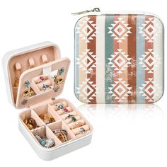 an open suitcase with jewelry in it on a white surface next to another case filled with rings and bracelets