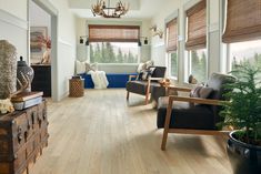 a living room filled with furniture and lots of windows