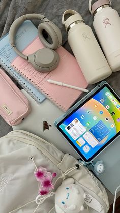 an assortment of personal items laid out on top of a bed next to each other