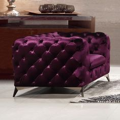 two purple chairs sitting next to each other in a living room