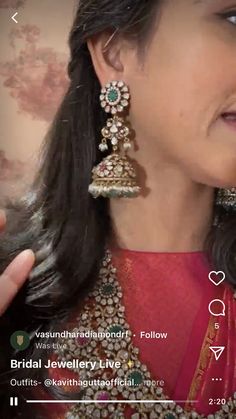 the woman is wearing some jewelry on her neck and holding something up to her ear