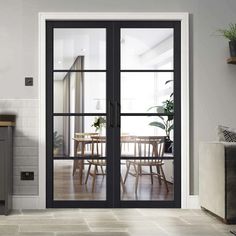 an open glass door leading to a dining room