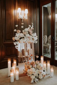 a table topped with lots of white flowers and candles