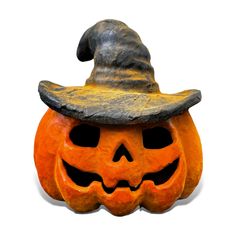 a carved pumpkin with a witches hat on it's head, against a white background