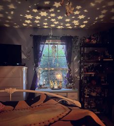 a bedroom with stars on the ceiling and curtains