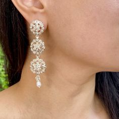 Featuring a pair of earrings handcrafted in 925 sterling silver. These earrings feature a classic floral design and have been adorned with precious pearls. A timeless classic, handcrafted with attention to every detail. The perfect touch of elegance for any occasion.