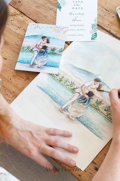 a woman is painting pictures on paper with watercolors