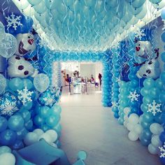 balloons and snowflakes decorate the entrance to an event