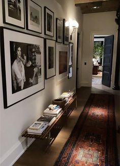 the hallway is decorated with black and white photos