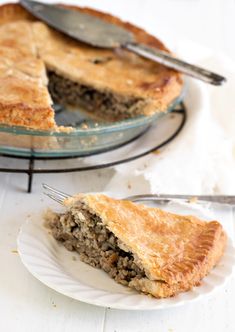 a piece of meat pie on a plate with a fork