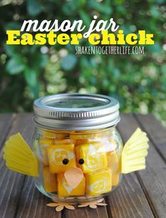 mason jar filled with easter chick candy on top of a wooden table