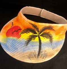 "Sun is shining  Classic Sun Visor for beach, hiking, pool alike  3.5\" deep with Velcro back strap - adjustable to most sizes from Small-to-XL Made from straw & paper braid, crushable/packable, SPF 50 in material Hand Painted Artwork - Paint to order Acrylic Paints used in artwork will not bleed if wet. Please allow for delivery times of 3-10 days. As this visor is custom made, there are no returns or exchanges but please contact me if there is a concern. Thanks much !! Enjoy" Adjustable Sun Hat For Beach Season Swimming, Adjustable Summer Sun Hat For Swimming, Adjustable Multicolor Sun Hat For Vacation, Adjustable Multicolor Sun Hat, Adjustable Hand Painted Sun Hat For Summer, Hand Painted Adjustable Sun Hat For Summer, Adjustable Hand-painted Sun Hat For Summer, Spring Beach Sun Hat Hand Painted, Multicolor Hand Painted Sun Hat For Vacation