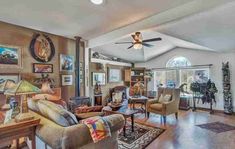 a living room with lots of furniture and pictures on the wall