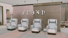 a set of five chairs sitting in front of a wall with letters on the side