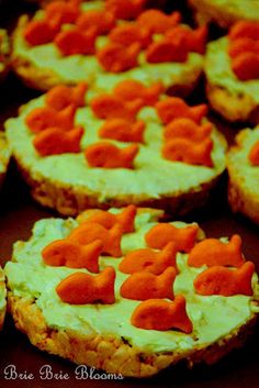 small crackers with carrots on them are arranged in the shape of fish and hearts