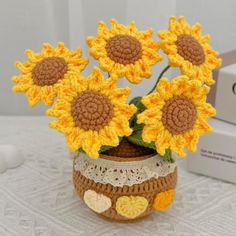 crocheted sunflowers in a vase on a table