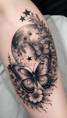 a woman's thigh with a butterfly and flowers on it, in front of the moon