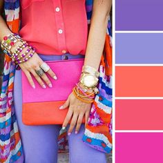 a woman wearing colorful clothing and accessories with her hands on her hip