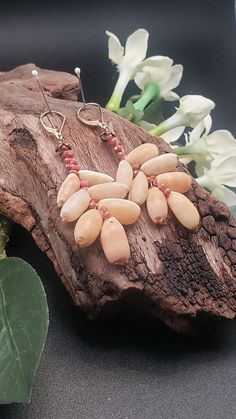 Soft tan colored Hawaiian Isabella Cowry shells are tied here together with vibrant dark pink Kahelelani shells in a fan shape. A fun and different style for the beach loving person!  Authentic Kahelelani shells from Niihau.  a perfect gift for that person with an out of the box style.  14kt goldfilled lever back earwires  2.5 inches long Authentic Hawaiian Shells Handmade Bohemian Apricot Jewelry, Beige Teardrop Bohemian Jewelry, Bohemian Beige Teardrop Jewelry, Handmade Apricot Bohemian Jewelry, Beige Bohemian Teardrop Jewelry, Bohemian Beige Teardrop Earrings, Beige Dangle Jewelry With Ear Wire, Beige Dangle Earrings With Ear Wire, Beige Jewelry With Dangling Beads For Gift