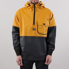 The Helly Hansen Roan Anorak in Ochre/Charcoal has a PU (Polyurethane) coating on 100% polyester making this jacket water and oil proof, lightweight and flexible. A click on loop at the chest holds an ID card holder along with a flap and press studded closure for the left chest pocket. A half zip gives an easy way to take on and off with ribbed cuffs and an adjustable drawstring hood and waistband to keep in the heat. Our model is 6ft tall with a 38" chest and wears a size Medium Helly Hansen Jacket, Patches Jacket, Outdoor Jacket, Waterproof Jacket, Hiking Outfit, Helly Hansen, Field Jacket, Mens Outerwear, Hoodie Design