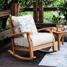 a rocking chair and table on a deck