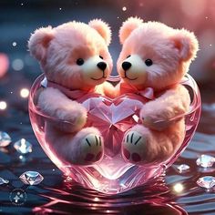 two teddy bears sitting on top of a heart shaped glass bowl filled with water and diamonds