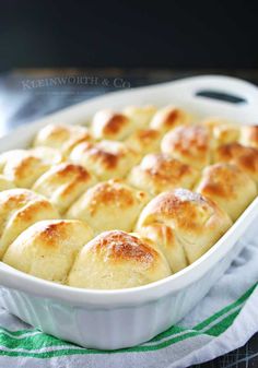 a casserole dish filled with bread on top of a green and white towel