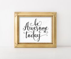 a black and white print with the words be awesome today in gold frame on a shelf