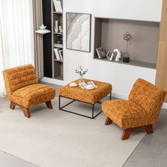 a living room with two orange chairs and a coffee table