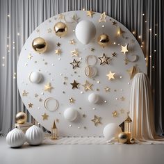 a white wall with gold stars and ornaments on it, next to a silver curtain