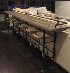 a long table with stools sitting in front of it