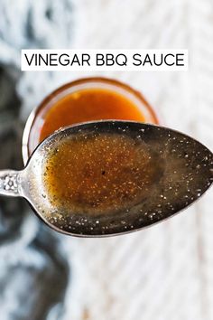 a spoon full of vinegar bbq sauce with the words vinegar bbq sauce on it