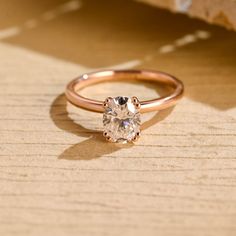 a diamond ring sitting on top of a wooden table