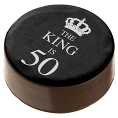 the king is forty birthday cake topper on a black and brown plate with white lettering