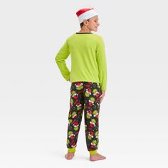 Surprise your kid during Christmas with The Grinch 2-Piece Cozy Pajama Set and Santa Hat. This two-piece pajama set includes a green sleep shirt, a pair of black pajama pants and a Santa hat for a festive look. The top showcases a print of the Grinch wearing a Santa outfit on skis with "Merry Grinchmas" text, while the bottom showcases allover Grinch faces wearing Santa hats and the name "Grinch" for holiday fun. Grinch Faces, Black Pajama Pants, Grinch Pajamas, The Grinch Christmas, Black Pajamas, Merry Grinchmas, Santa Outfit, Cozy Pajamas, Santa Hats