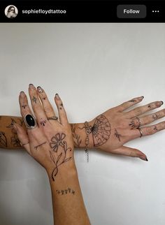 two hands with tattoos on them are touching each other's palms and fingers