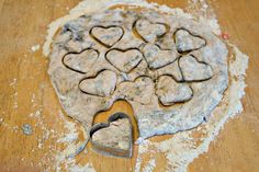 a heart shaped cookie sitting on top of a wooden table