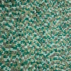 an area rug with green and grey colors on it, including squares in the middle