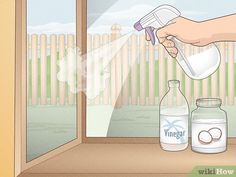 a person is spraying vinegar on the window sill