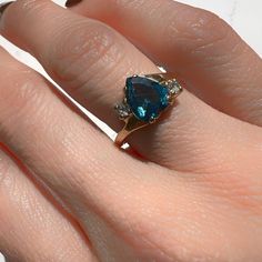 London Blue Topaz Ring 14K Yellow Gold Heart Shape Blue Topaz 8mm x 6.2mm 1.9gm Size 5.5 Sizing available with fee contact us to have it added to the price before check out. Thank you for visiting our shop! Visit our website DmKJewelry.com Also Follow us on Instagram https://www.instagram.com/dmkjewelry_/ Blue Trillion Cut Topaz Ring With Accent Stones, Blue Topaz Trillion Cut Ring, Blue Trillion-cut Topaz Ring, Blue Trillion Cut Topaz Ring, Pear-shaped Blue Topaz Ring, Fine Jewelry Blue Pear-shaped Topaz Ring, Blue Topaz Ring With Pear-shaped Center Stone, Blue Topaz Pear-shaped Ring With Center Stone, Fine Blue Topaz Ring Pear-shaped