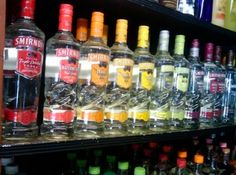 bottles of alcohol are lined up on the shelf