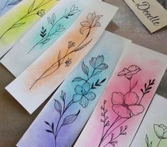 four watercolor cards with flowers on them