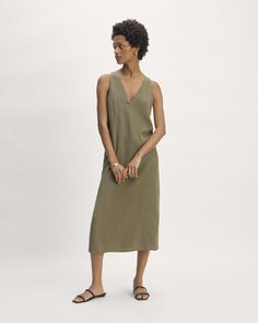 About This Style. This piece features a relaxed fit, midi-length, sleeveless, v-neck in front and back, full lining, slightly fitted waist and side slits. Midi Slip Dress, Maxi Slip Dress, Black Khakis, V Neck Dress, Midi Length, Jumpsuit Dress, Slip Dress, Top Brands, Relaxed Fit