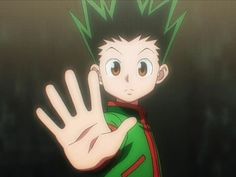 an anime character is holding his hand up in front of him with one hand out to the side