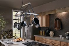 pots and pans hanging from the ceiling in a kitchen