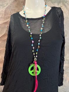 Beth's Addiction We all know the peace sign is timeless. We had so much fun picking these out at Dallas Apparel Mart. We couldn't decide so we just got all of the best ones. Enjoy!! Hand beaded peace sign necklaces in multiple colors. Peace Sign Hippie Pendant Necklace No two are identical. Each one is Meticulously Handcrafted. Adjustable loop to wear at the desired length. Proudly Made in America Hippie Style Green Beaded Necklace For Festivals, Green Hippie Beaded Necklaces, Hippie Green Round Bead Necklaces, Green Beaded Hippie Necklace, Hippie Green Jewelry With Colorful Beads, Hippie Green Round Beads Jewelry, Hippie Green Round Beaded Jewelry, Hippie Green Beaded Necklace, Handmade Hippie Green Beaded Necklaces