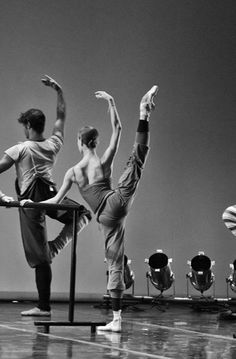 three men are doing ballet moves on the stage